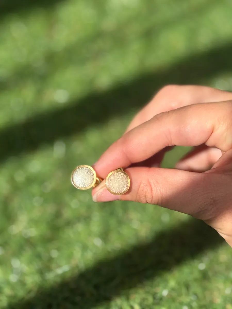 Boucles d'oreilles puces au lait maternel tenues au soleil